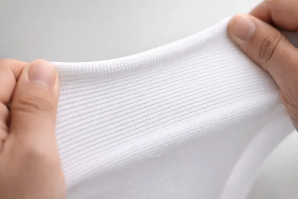 bügelfreie Tischhussen Material Polyester Elastan Detail elastischer Stoff Nahaufnahme